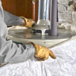 plumber-installing-water-heater-jacket