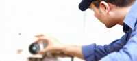 man checking out hot water heater