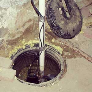 a sump pit in scarborough home, the sump pit lid is visible and has been removed from the pit