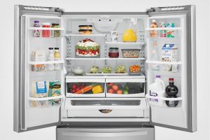 refrigerator open with produce after being service by a plumber